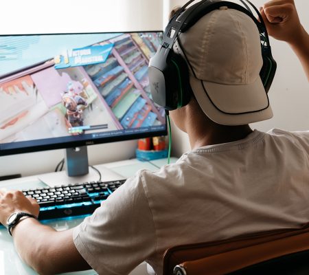 man playing video games carefully to prevent e-sports injury